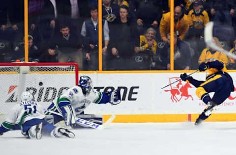 NASHVILLE, TN – JANUARY 10: Nashville Predators center Calle Jarnkrok (19) scores the winning goal past Vancouver Canucks goalie Ryan Miller (30) at Bridgestone Arena. The Predators won 2-1 in overtime. Photo by Christopher Hanewinckel/USA TODAY Sports)