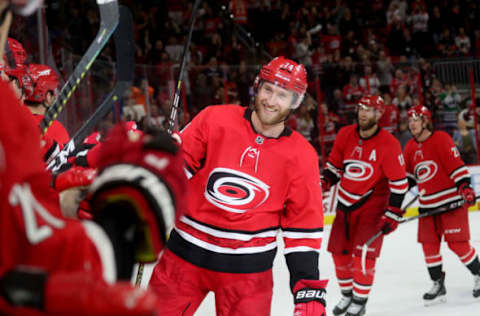 RALEIGH, NC – MARCH 30: Jaccob Slavin #74 of the Carolina Hurricanes scores an empty net goal and celebrates with teammates during an NHL game against the Philadelphia Flyers on March 30, 2019 at PNC Arena in Raleigh, North Carolina. (Photo by Gregg Forwerck/NHLI via Getty Images)