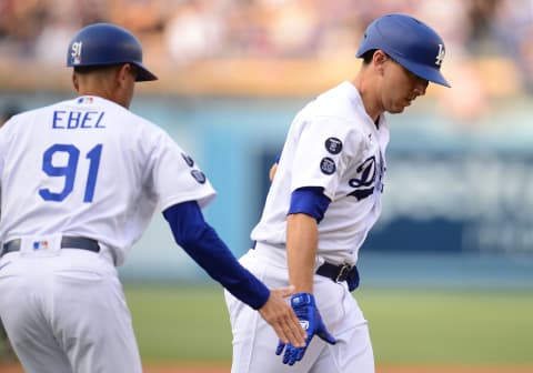 Jul 24, 2021; Los Angeles, California, USA; Los Angeles Dodgers catcher Austin Barnes (15) is greeted by third base coach Dino Ebel (91) after hitting a solo home run against the Colorado Rockies at Dodger Stadium. Mandatory Credit: Gary A. Vasquez-USA TODAY Sports