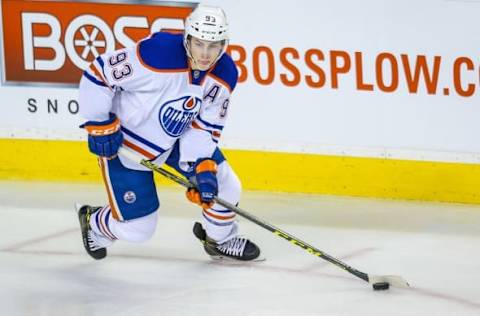 Dec 27, 2015; Calgary, Alberta, CAN; Edmonton Oilers center Ryan Nugent-Hopkins (93) controls the puck against the Calgary Flames during the second period at Scotiabank Saddledome. Mandatory Credit: Sergei Belski-USA TODAY Sports