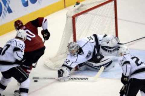 Feb 2, 2016; Glendale, AZ, USA; Los Angeles Kings goalie Jonathan Quick (32) plays the puck against the Arizona Coyotes during the third period at Gila River Arena. The Kings won 6-2. Mandatory Credit: Joe Camporeale-USA TODAY Sports