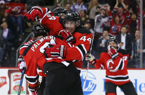 Feb 3, 2017; Newark, NJ, USA; New Jersey Devils left wing Miles Wood (44) and right wing Kyle Palmieri (21) celebrate Palmieri’s goal during the second period at Prudential Center. Mandatory Credit: Ed Mulholland-USA TODAY Sports