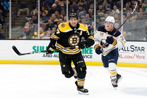 BOSTON, MA – JANUARY 05: Boston Bruins center Patrice Bergeron (37) and Buffalo Sabres center Casey Mittelstadt (37) chase the puck during a game between the Boston Bruins and the Buffalo Sabres on January 5, 2019, at TD Garden in Boston, Massachusetts. (Photo by Fred Kfoury III/Icon Sportswire via Getty Images)