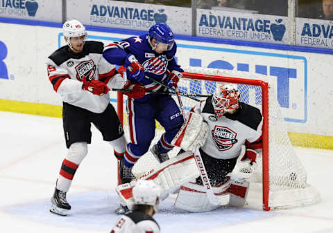 Amerks Brandon Biro redirects a shot past Utica goalie Akira Schmid. Rochester won in OT 4-3.