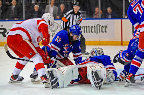 Feb 17, 2022; New York, New York, USA; New York Rangers goaltender Igor Shesterkin (31) tries to stop a bouncing puck while New York Rangers center Mika Zibanejad (93) defends against the Detroit Red Wings during the first period at Madison Square Garden. Mandatory Credit: Danny Wild-USA TODAY Sports