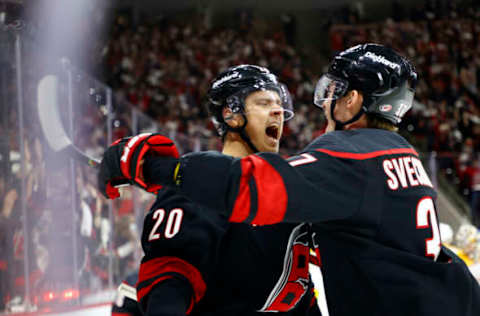 RALEIGH, NORTH CAROLINA – MAY 19: Sebastian Aho #20 of the Carolina Hurricanes celebrates with teammate Andrei Svechnikov #37 following a goal scored during the first period in Game Two of the First Round of the 2021 Stanley Cup Playoffs against the Nashville Predators at PNC Arena on May 19, 2021, in Raleigh, North Carolina. (Photo by Jared C. Tilton/Getty Images)