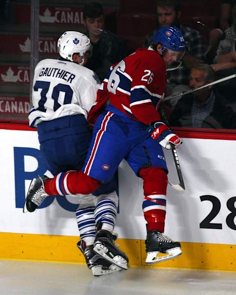 Sep 22, 2015; Montreal, Quebec, CAN; Toronto Maple Leafs centre Frederick Gauthier (70) is checked into the boards by Montreal Canadiens defenseman Jeff Petry (26) during the third period at Bell Centre. Mandatory Credit: Jean-Yves Ahern-USA TODAY Sports