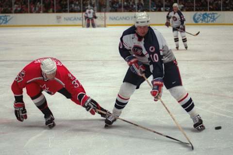 16 Feb 1998: John LeClair of the USA and Eric Desjardins of Canada (Mandatory Credit: Doug Pensinger /Allsport)