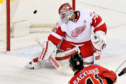 Mar 3, 2017; Calgary, Alberta, CAN; Calgary Flames center Mikael Backlund (11) scores on Detroit Red Wings goalie Petr Mrazek (34) during overtime at Scotiabank Saddledome. The Flames won 3-2 in overtime. Mandatory Credit: Candice Ward-USA TODAY Sports