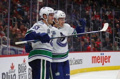 DETROIT, MICHIGAN – OCTOBER 22: Jake Virtanen #18 of the Vancouver Canucks celebrates his third period goal with Bo Horvat #53 while playing the Detroit Red Wings at Little Caesars Arena on October 22, 2019 in Detroit, Michigan. Vancouver won the game 5-2. (Photo by Gregory Shamus/Getty Images)