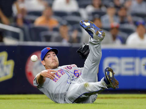 NEW YORK, NY – AUGUST 13: Pitcher Seth Lugo #67 of the New York Mets fields a bunt and throws to first base during the 8th inning during an interleague MLB baseball game against the New York Yankees on August 13, 2018 at Yankee Stadium in the Bronx borough of New York City. Mets won 8-5. This was a makeup game from a rainout of July 22. (Photo by Paul Bereswill/Getty Images)