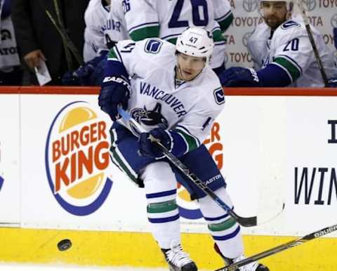 Mar 22, 2016; Winnipeg, Manitoba, CAN; Vancouver Canucks left wing Sven Baertschi (47) shoots the puck in the neutral zone in the first period at MTS Centre. Mandatory Credit: James Carey Lauder-USA TODAY Sports