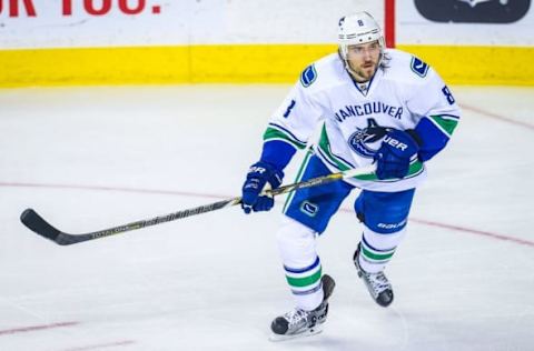 Feb 19, 2016; Calgary, Alberta, CAN; Vancouver Canucks defenseman Chris Tanev (8) skates against the Calgary Flames during the second period at Scotiabank Saddledome. Calgary Flames won 5-2. Mandatory Credit: Sergei Belski-USA TODAY Sports