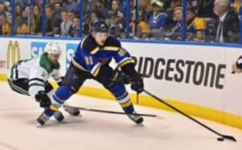 May 9, 2016; St. Louis, MO, USA; Dallas Stars defenseman Kris Russell (2) reaches for the puck on St. Louis Blues right wing Vladimir Tarasenko (91) during the second period in game six of the second round of the 2016 Stanley Cup Playoffs at Scottrade Center. Mandatory Credit: Jasen Vinlove-USA TODAY Sports