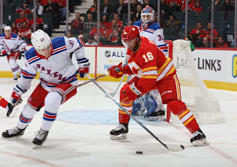 CALGARY, AB – JANUARY 2: Tobias Rieder #16 of the Calgary Flames protects the puck against Adam Fox #23 of the New York Rangers at Scotiabank Saddledome on January 2, 2020 in Calgary, Alberta, Canada. (Photo by Gerry Thomas/NHLI via Getty Images)