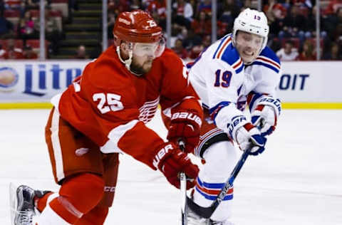 Mar 12, 2016; Detroit, MI, USA; Detroit Red Wings defenseman Mike Green (25) skates with the puck chased by New York Rangers right wing Jesper Fast (19) in the second period at Joe Louis Arena. Mandatory Credit: Rick Osentoski-USA TODAY Sports