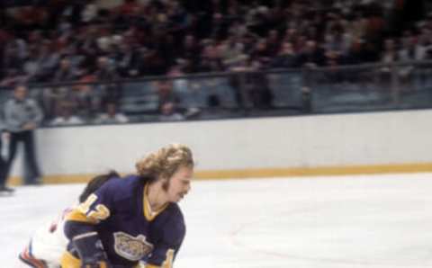 NEW YORK, NY – 1974: Gene Carr #12 of the Los Angeles Kings skates with the puck during an NHL game against the New York Rangers circa 1974 at the Madison Square Garden in New York, New York. (Photo by Melchior DiGiacomo/Getty Images)