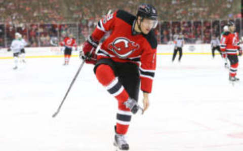 New Jersey Devils left wing Taylor Hall (9) cleans off his skate and shows off the New Jersey home jersey (Ed Mulholland-USA TODAY Sports)