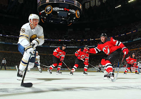 BUFFALO, NY – OCTOBER 5: Rasmus Ristolainen #55 of the Buffalo Sabres controls the pucks against Sami Vatanen #45 of the New Jersey Devils during an NHL game on October 5, 2019 at KeyBank Center in Buffalo, New York. (Photo by Bill Wippert/NHLI via Getty Images)