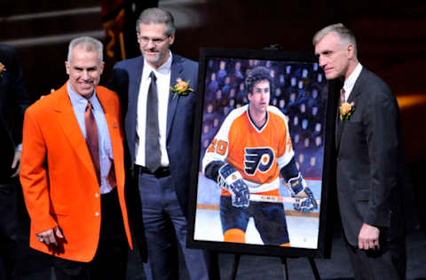 Feb 29, 2016; Philadelphia, PA, USA; Philadelphia Flyers former defensemen Jimmy Watson (left) poses with Flyers general manager Ron Hextall and president Paul Hextall during induction into the Flyers Hall of Fame prior to game against the Calgary Flames at Wells Fargo Center. Mandatory Credit: Eric Hartline-USA TODAY Sports