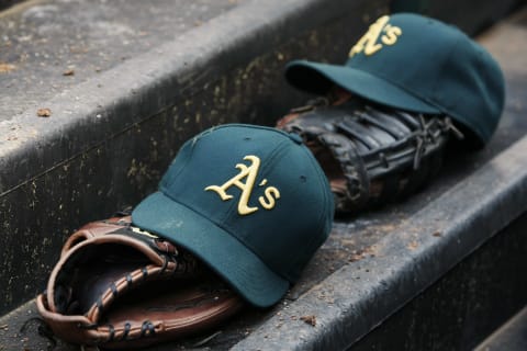 ARLINGTON, TX – MAY 21: Oakland Athletics hats and gloves during a baseball game against the Texas Rangers at Rangers Ballpark on May 21, 2013 in Arlington, Texas. Oakland Athletics won 1-0. (Photo by Brandon Wade/Getty Images)