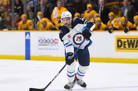 Jan 24, 2023; Nashville, Tennessee, USA; Winnipeg Jets defenseman Dylan DeMelo (2) passes the puck against the Nashville Predators during the second period at Bridgestone Arena. Mandatory Credit: Steve Roberts-USA TODAY Sports