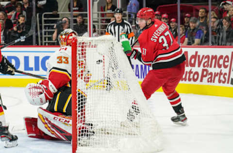 RALEIGH, NC – OCTOBER 29: Carolina Hurricanes Left Wing Andrei Svechnikov (37) uses a lacrosse move to lift the puck behind Calgary Flames Goalie David Rittich (33) during a game between the Calgary Flames and the Carolina Hurricanes at the PNC Arena in Raleigh, NC on October 29, 2019. (Photo by Greg Thompson/Icon Sportswire via Getty Images)