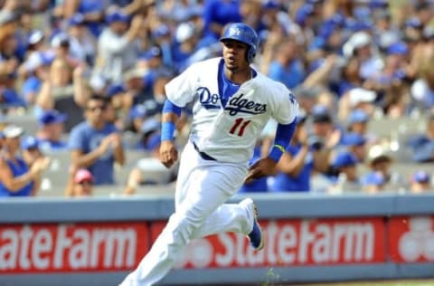 September 28, 2014; Los Angeles, CA, USA; Los Angeles Dodgers shortstop Erisbel Arruebarrena (11) scores a run in the sixth inning against the Colorado Rockies at Dodger Stadium. Mandatory Credit: Gary A. Vasquez-USA TODAY Sports