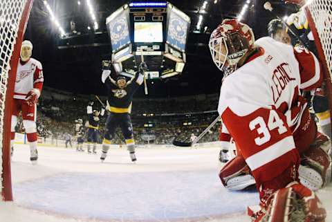 NASHVILLE, TN – APRIL 13: Goalie Manny Legace #34 of the Detroit Red Wings Vladimir Orszagh #33 of the Nashville Predators  (Photo by Brian Bahr/Getty Images)