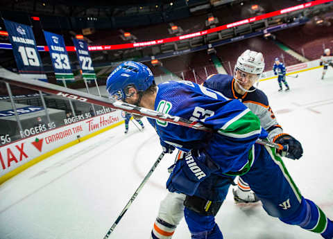 May 3, 2021; Vancouver, British Columbia, CAN; Edmonton Oilers forward Alex Chiasson (39) checks Vancouver Canucks defenseman Alexander Edler (23) in the third period at Rogers Arena. Oilers won 5-3. Mandatory Credit: Bob Frid-USA TODAY Sports