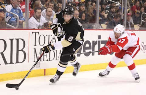 Feb 18, 2016; Pittsburgh, PA, USA; Pittsburgh Penguins defenseman Brian Dumoulin (8) moves the puck against pressure from Detroit Red Wings center Brad Richards (17) during the third period at the CONSOL Energy Center. The Penguins won 6-3. Mandatory Credit: Charles LeClaire-USA TODAY Sports