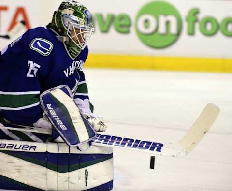 Jan 9, 2016; Vancouver, British Columbia, CAN; Vancouver Canucks goaltender Jacob Markstrom (25) stops the puck after a shot by the Tampa Bay Lightning during the second period at Rogers Arena. Mandatory Credit: Anne-Marie Sorvin-USA TODAY Sports