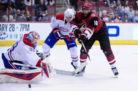 Feb 15, 2016; Glendale, AZ, USA; Arizona Coyotes left wing Anthony Duclair (10) shoots on Montreal Canadiens goalie Mike Condon (39) and center Lars Eller (81) defends during the second period at Gila River Arena. Mandatory Credit: Matt Kartozian-USA TODAY Sports