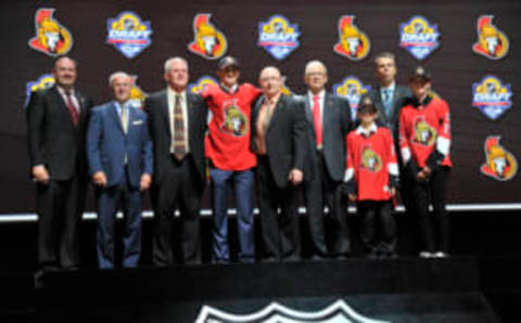 Jun 26, 2015; Sunrise, FL, USA; Colin White poses for a photo with team executives after being selected as the number twenty-one overall pick to the Ottawa Senators in the first round of the 2015 NHL Draft at BB&T Center. Mandatory Credit: Steve Mitchell-USA TODAY Sports