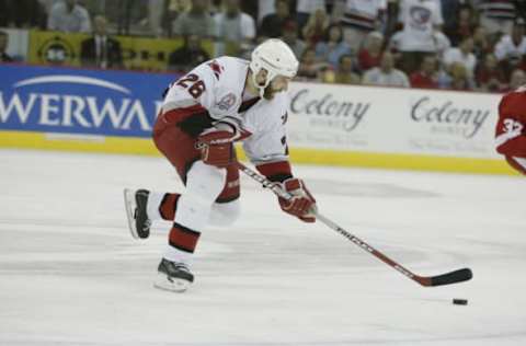 RALEIGH, NC – JUNE 8: Left Wing Erik Cole #26 of the Carolina Hurricanes skates with the puck against the Detroit Red Wings during game three of the NHL Stanley Cup Finals at the Entertainment and Sports Arena in Raleigh, North Carolina on June 8, 2002. The Red Wings defeated the Hurricanes in triple overtime 3-2. (Photo by Elsa/Getty Images/NHLI)