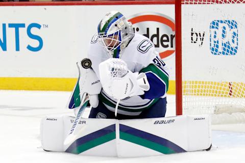 Jan 10, 2023; Pittsburgh, Pennsylvania, USA; Vancouver Canucks goaltender Spencer Martin (30) makes a save against the Pittsburgh Penguins during the first period at PPG Paints Arena. The Penguins won 5-4. Mandatory Credit: Charles LeClaire-USA TODAY Sports