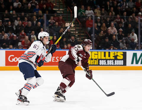 OSHAWA, ON – DECEMBER 13: Ryan Gagnier #67 of the Oshawa Generals and Mason Mctavish #23 of the Peterborough Petes skate up the ice during an OHL game at the Tribute Communities Centre on December 13, 2019 in Oshawa, Ontario, Canada. (Photo by Chris Tanouye/Getty Images)