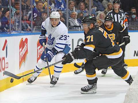 TORONTO, ON – NOVEMBER 6: Taylor Hall #71 of the Boston Bruins tries to trap a puck against Travis Dermott #23 of the Toronto Maple Leafs   (Photo by Claus Andersen/Getty Images)