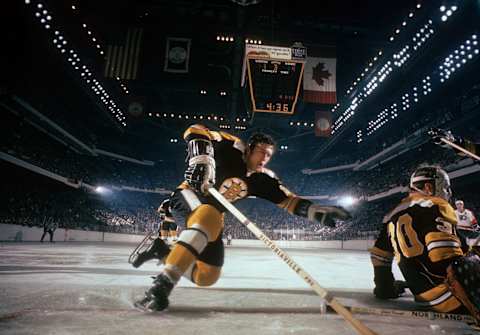 BOSTON, MA – 1969: Don Awrey #26 of the Boston Bruins falls towards the net behind goalie Gerry Cheevers #30 during an NHL game against the Philadelphia Flyers circa 1969 at the Boston Garden in Boston, Massachusetts. (Photo by Melchior DiGiacomo/Getty Images)