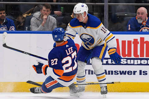 Mar 7, 2023; Elmont, New York, USA; Buffalo Sabres defenseman Henri Jokiharju (10) checks New York Islanders left wing Anders Lee (27) along the boards during the third period at UBS Arena. Mandatory Credit: Dennis Schneidler-USA TODAY Sports