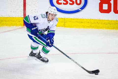 Jan 16, 2021; Calgary, Alberta, CAN; Vancouver Canucks defenseman Quinn Hughes (43) skates with the puck against the Calgary Flames during the first period at Scotiabank Saddledome. Mandatory Credit: Sergei Belski-USA TODAY Sports