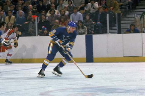 Canadian hockey player Gordon ‘Red’ Berenson, forward for the St. Louis Blues, skates the puck up the ice against the Scouts, Kansas City, Missouri, January 1975. (Photo by Bruce Bennett Studios/Getty Images)