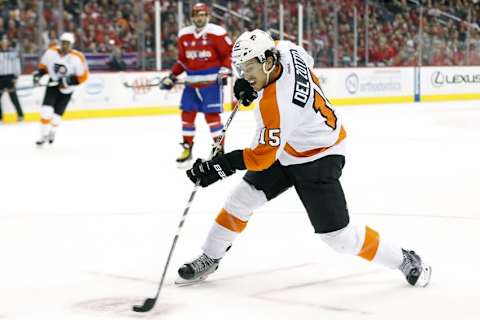 Feb 7, 2016; Washington, DC, USA; Philadelphia Flyers defenseman Michael Del Zotto (15) shoots the puck as Washington Capitals left wing Alex Ovechkin (8) looks on in the first period at Verizon Center. Mandatory Credit: Geoff Burke-USA TODAY Sports