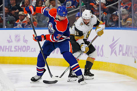 Nov 28, 2023; Edmonton, Alberta, CAN; Edmonton Oilers defensemen Darnell Nurse (25)and Vegas Golden Knights forward Jonathan Marchessault (81) battle for a loose puck during the second period at Rogers Place. Mandatory Credit: Perry Nelson-USA TODAY Sports