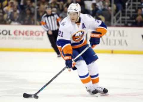 Jan 2, 2016; Pittsburgh, PA, USA; New York Islanders right wing Kyle Okposo (21) carries the puck against the Pittsburgh Penguins during the third period at the CONSOL Energy Center. The Penguins won 5-2. Mandatory Credit: Charles LeClaire-USA TODAY Sports