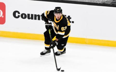 Jan 26, 2021; Boston, Massachusetts, USA; Boston Bruins center Brad Marchand (63) skates with the puck during the second period of a game against the Pittsburgh Penguins at the TD Garden. Mandatory Credit: Brian Fluharty-USA TODAY Sports