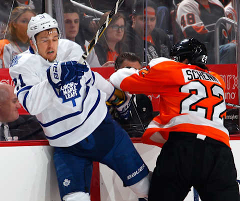 Toronto Maple Leafs – James van Riemsdyk #21 checked by Luke Schenn #22 (Photo by Paul Bereswill/Getty Images)