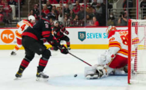 Nov 26, 2022; Raleigh, North Carolina, USA; Calgary Flames goaltender Dan Vladar (80) kicks out Carolina Hurricanes right wing Stefan Noesen (23) shot past center Jack Drury (18) during the first period at PNC Arena. Mandatory Credit: James Guillory-USA TODAY Sports