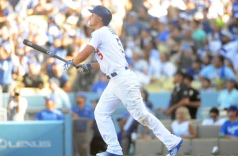 September 25, 2016; Los Angeles, CA, USA; Los Angeles Dodgers shortstop Corey Seager (5) hits a solo home run in the ninth inning against the Colorado Rockies at Dodger Stadium. Mandatory Credit: Gary A. Vasquez-USA TODAY Sports