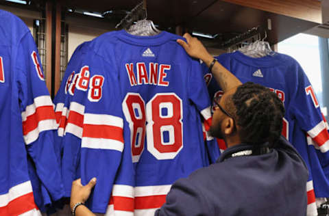 NEW YORK, NEW YORK – MARCH 02: A concession worker straightens up jerseys with “Patrick Kane #88” sewn on prior to Kane’s first game with the team against the Ottawa Senators at Madison Square Garden on March 02, 2023, in New York City. (Photo by Bruce Bennett/Getty Images)